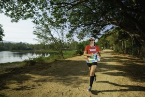 Runner on scenic trail near lake Thailand