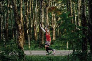 Runner celebrating with raised arms during Laguna Phuket Marathon 2025