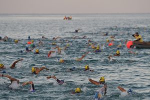 Triathletes swimming in Andaman Sea during IRONMAN Phuket