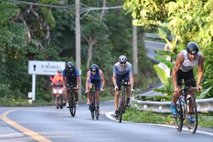 Triathletes racing on bike course during IRONMAN Thailand