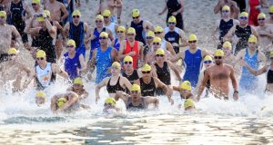 Triathletes diving into water at race start in Thailand