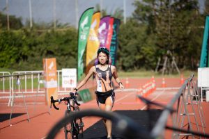 Kid pushing bike in triathlon Pho3nix Kids